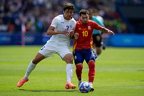 Abdukodir Khusanov and Alex Baena compete for the ball